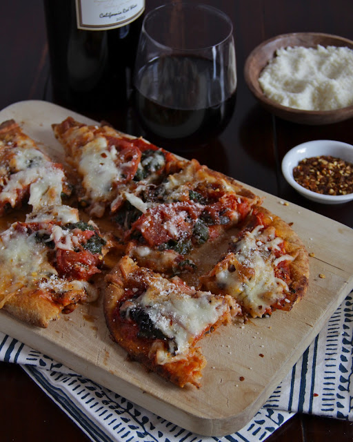 heirloom tomato, rainbow chard, and bacon naan pizza