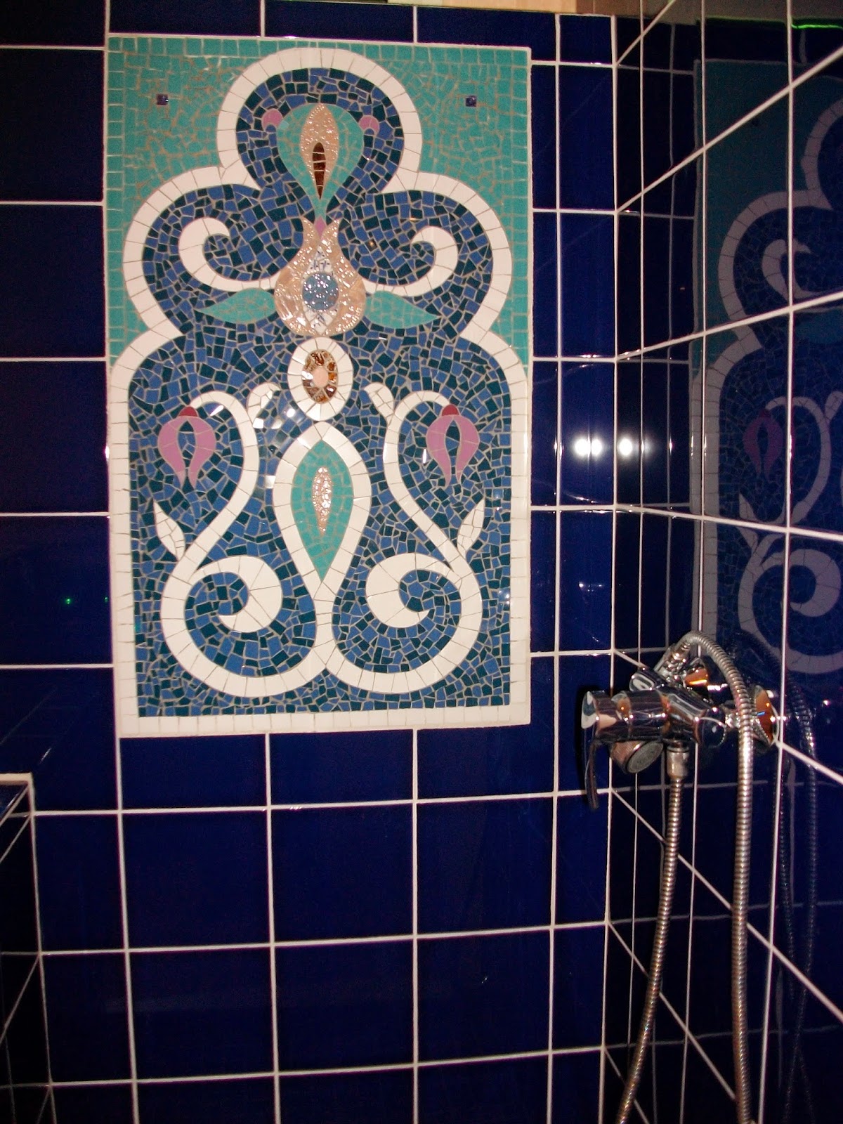 panneau mural en mosaique blanc et bleu en faïence fleur et arabesques orientaux créé pour une douche salle de bains apr mosaiste severine peugniez