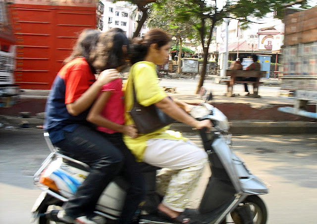 three girls on a scooter