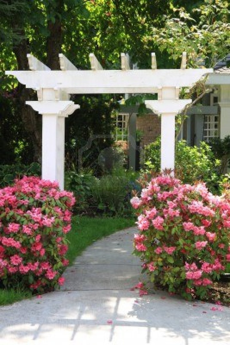Pretty garden arbor with pink flowers Express Photos