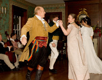 dancers in the ballroom at locust grove during the candlelight tour demonstration dances from the early 1800s and dressed in period costumes one man in a kilt and one in a soldiers outfit and ladies in long white gowns