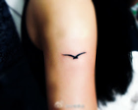 Flying goose tattoo on the arm