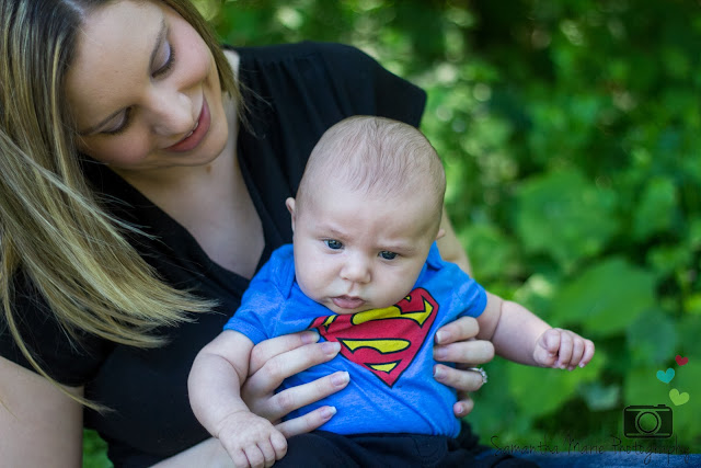 mom holding baby in Superman shirt