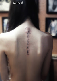 Beautiful sanskrit tattoo on the back align with the spine