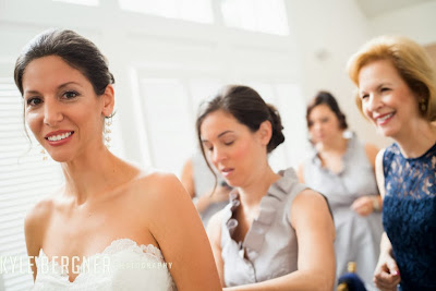 Bridesmaids and Mom helping the Bride get ready