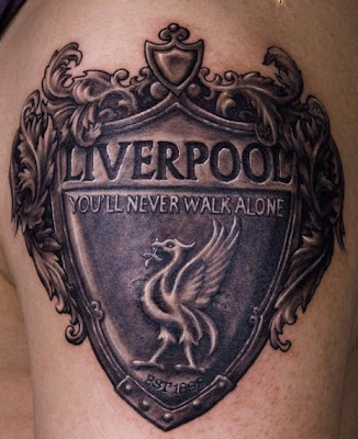 a tattoo featuring the emblem for the liverpool football club on the arm