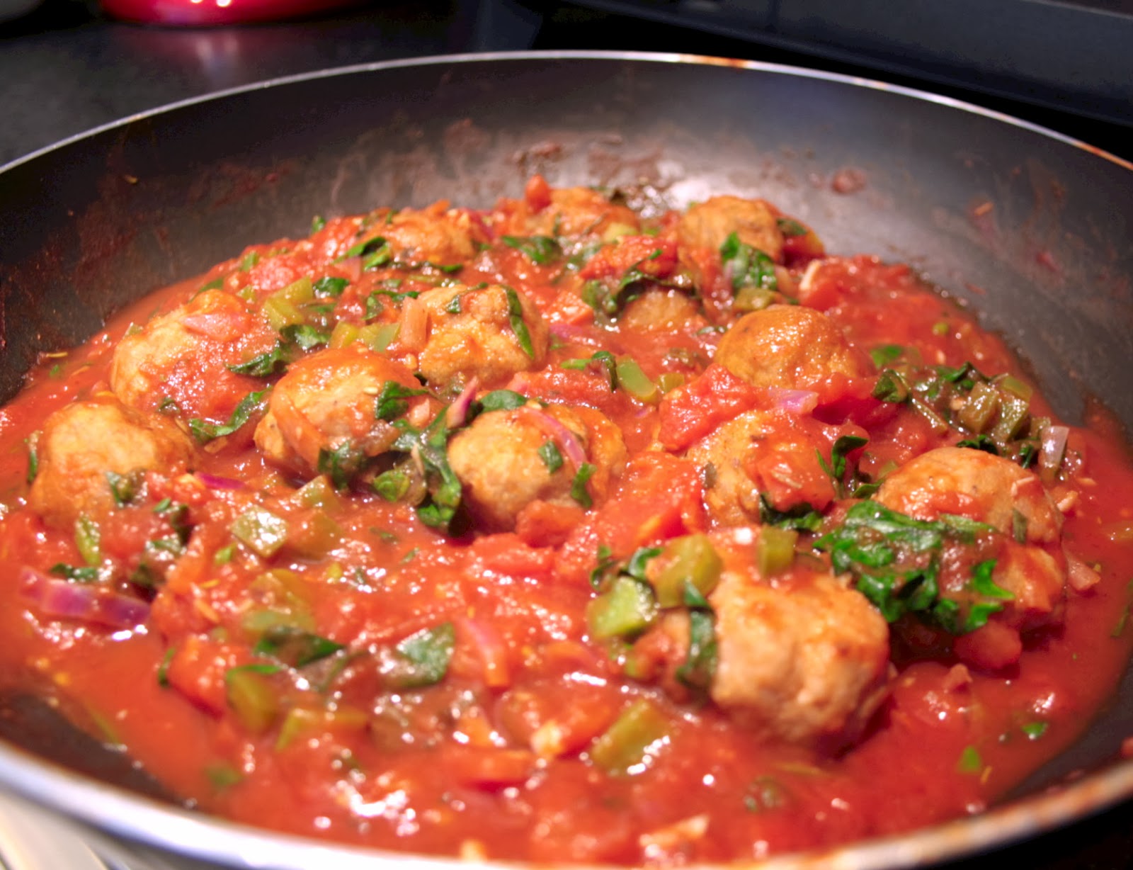 Turkey meatballs with a green pepper and spinach tomato sauce.  A healthier alternative to beef balls