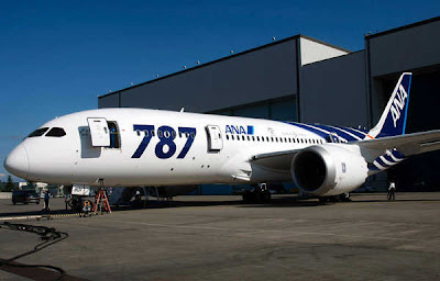 a large white airplane with blue stripes