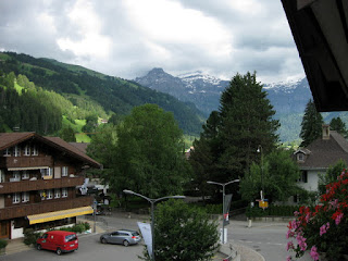 View of green hills and distant snow-streaked peak from pep's hotel room, Lenk im Simmental, Switzerland