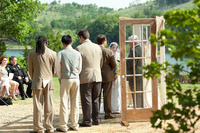 The wedding ceremony from the back, showing the french door backdrop. #taupe #FrenchDoorWedding