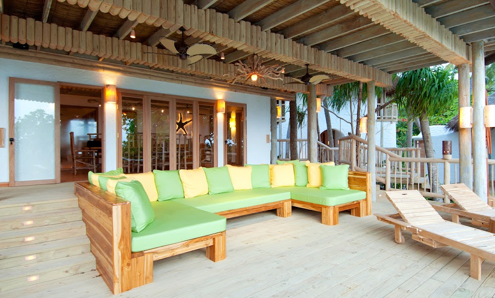 Photo of large wooden couch on the covered terrace