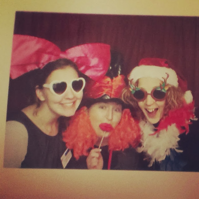 Three girls being silly in a photo booth