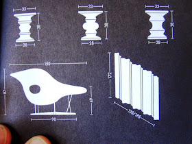 Close up of a page in a vitra catalogue, showing measurements for Eames stools.