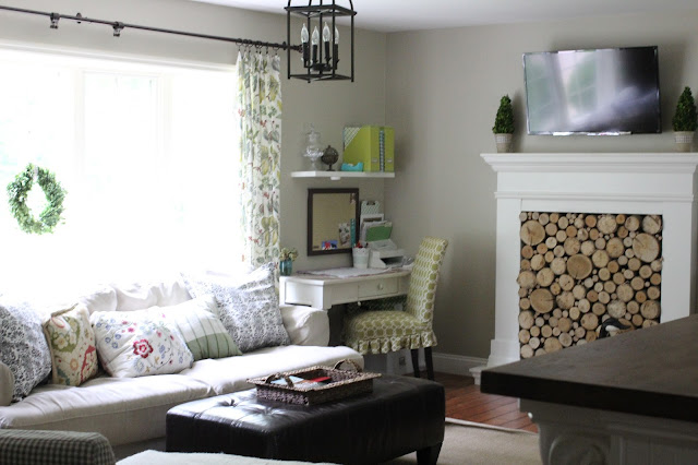 Behr Castle Path paint, Ikea Hovas sofa, faux fireplace with stacked wood birch logs via www.goldenboysandme,com