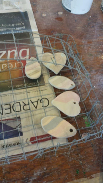 Ceramic pendants glazed and ready for raku firing.
