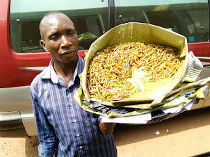 Hawker selling Krill fish at Kisenyi bus terminus.