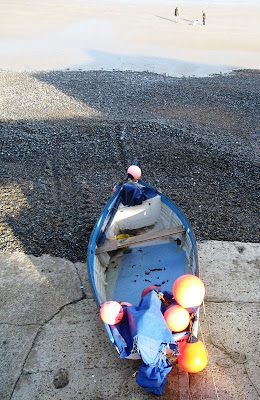 Blue boat waiting on the beach