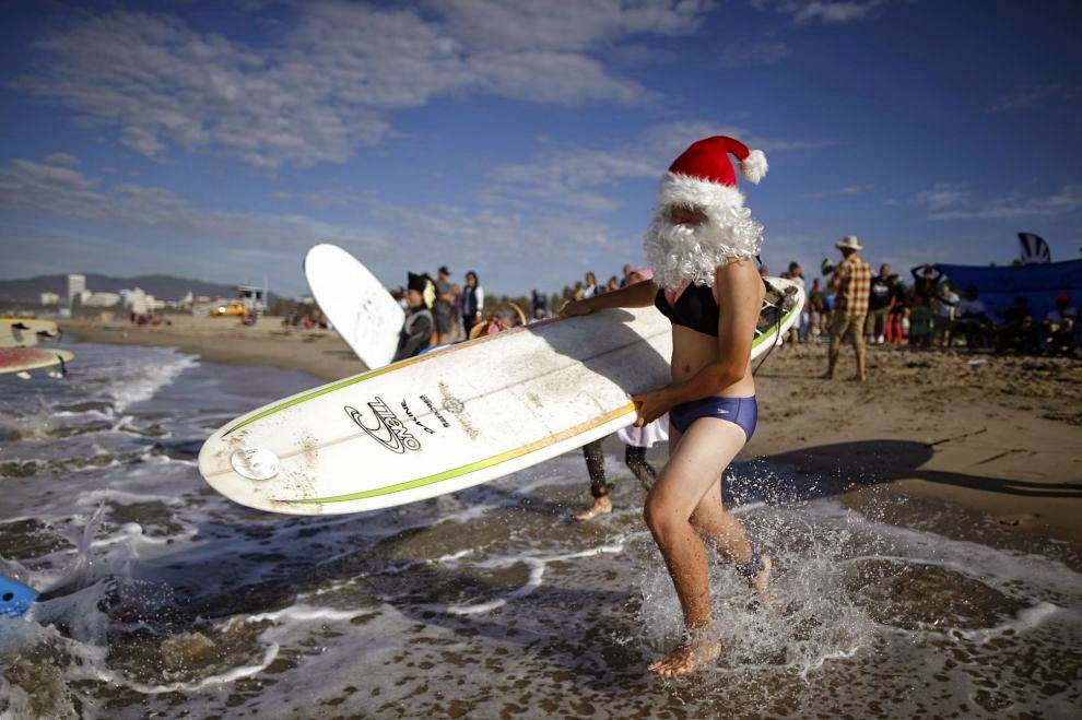 Halloween Surf Contest 2014 Competitors run into the Pacific Ocean during the 7th annual ZJ Boarding House Haunted Heats Halloween surf contest. (REUTERS/Lucy Nicholson)