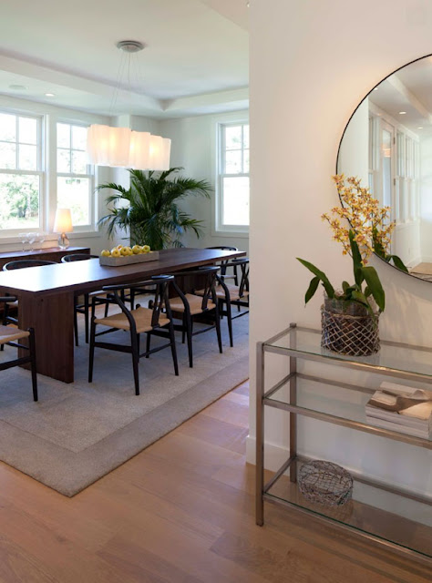 Black Oak Wishbone Chairs with Natural Papercord Seats (Apartment Design by Charlie Simmons - Charlie & Co. Design, Ltd.).  The beautiful glass pendant light fixture is the Artemide Logico Triple Linear Chandelier by Stardust Modern Design.