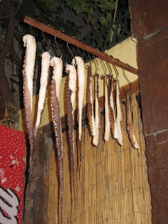 Octopus tentacles hanging to dry outside the restaurant.