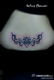 a lower back abstract lotus flower tattoo