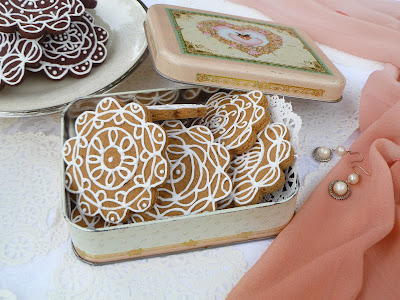 pink heart tin of decorated gingerbread cookies and dark-chocolate tea biscuits, pearls