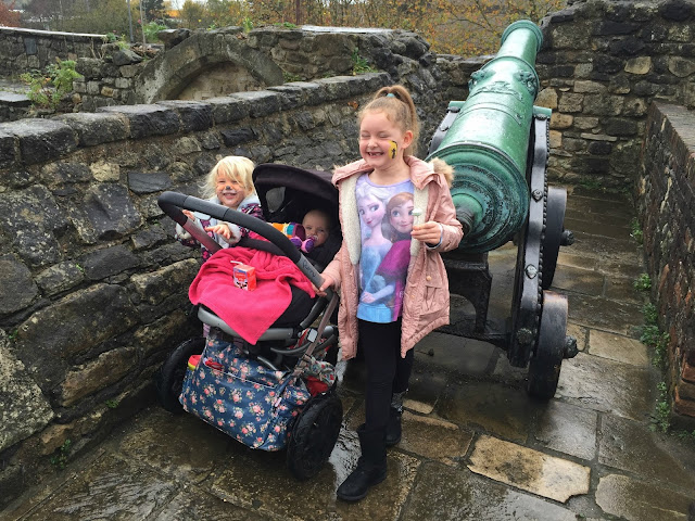 Tin Box Tot, Baby and friend stood by a medieval cannon