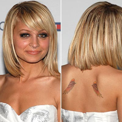 tattoos for women on shoulder blade. Angel Wings on Her Shoulder Blades 3. "Richie" and a Ribbon on the Back of 