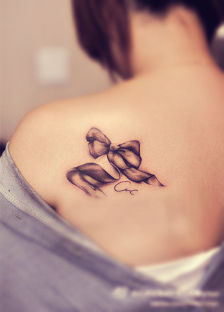 bow tattoo on the back