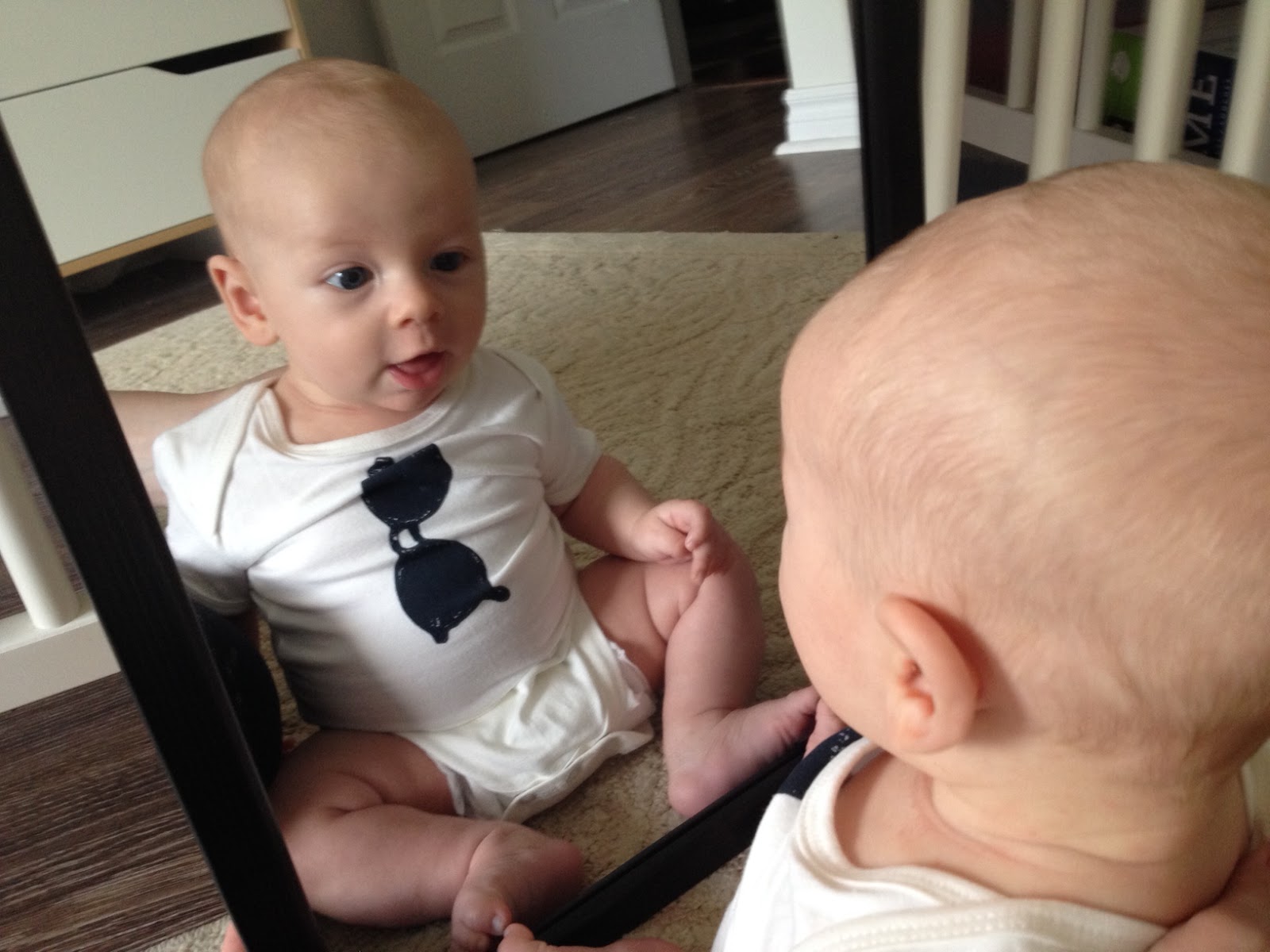 isavirtue baby looking in the mirror