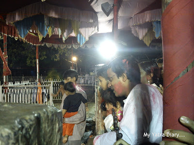 Devotees look on as Ganesh Visarjan takes place in a local Ganesha Temple