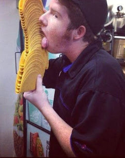 Taco Bell employee licks a stack of crunchy taco shells