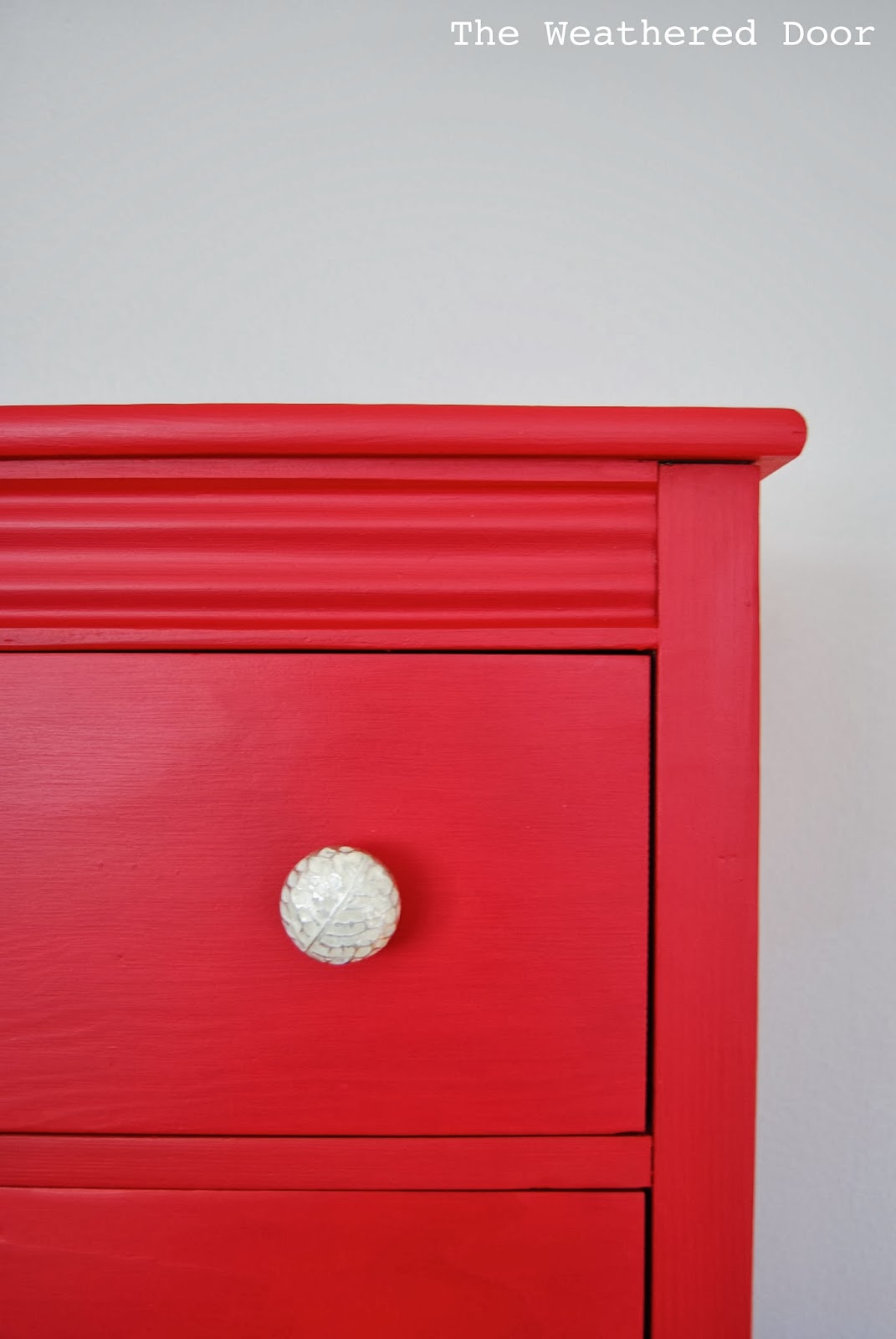A Tall Red Dresser With Silver And White Knobs The Weathered Door