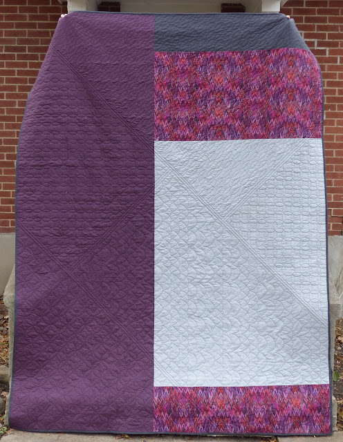 Vertical photo of purple and grey back of Carsick quilt