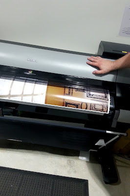 A1-sized photo being printed on a large printer.