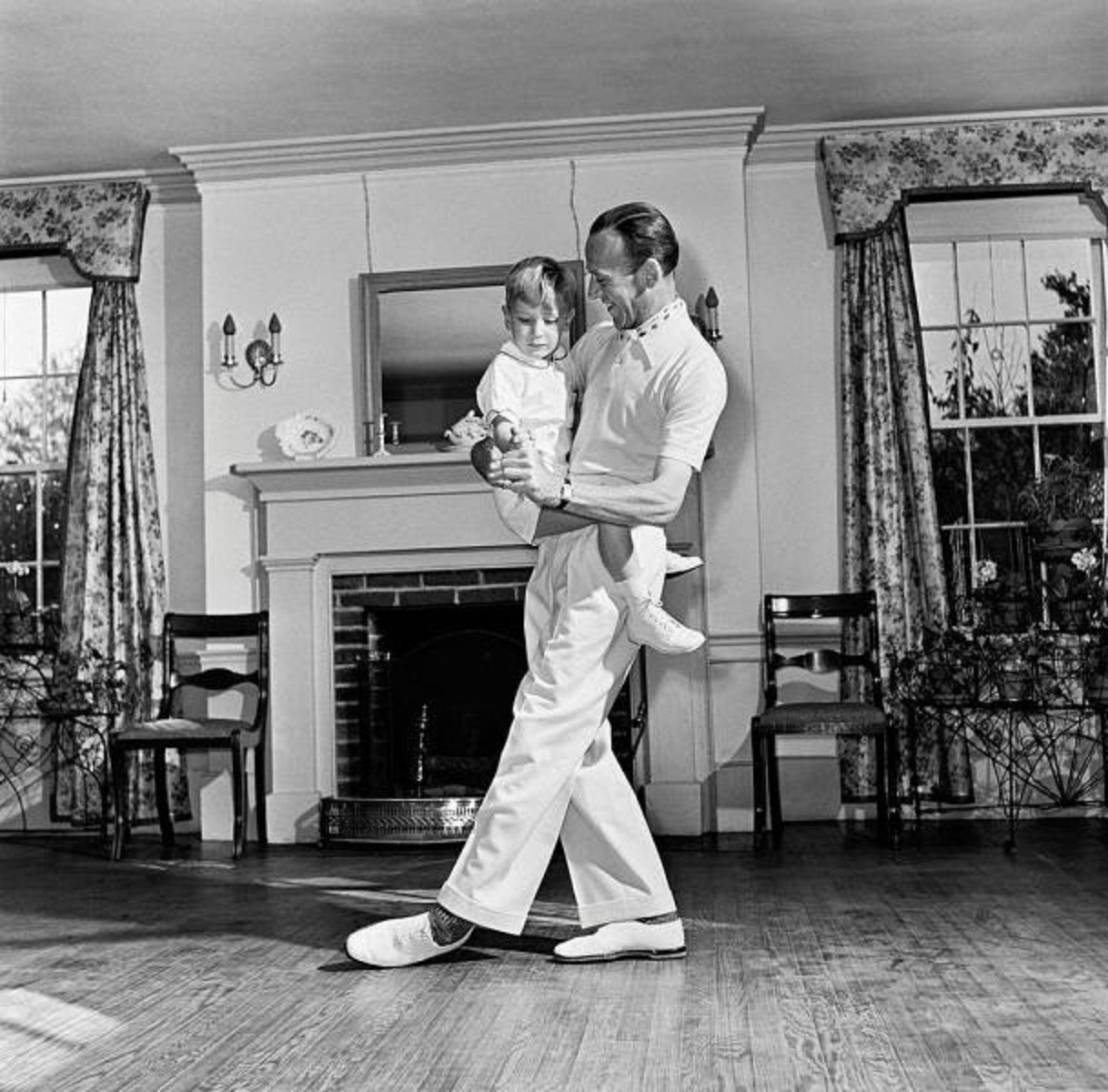 Fred Astaire dancing around the room with his young son