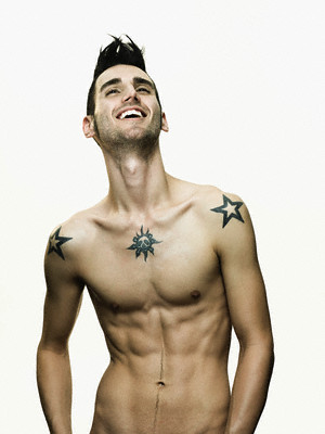 Skull tattoo right in the middle of a young man's chest and stars tattoo on