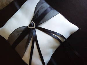 white ring cushion with black ribbon and silver heart £8.50