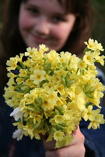 Girl holding yellow flowers
