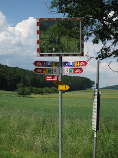 Self-portrait with bike route signs near the Rhine, near Ramsen, Switzerland.