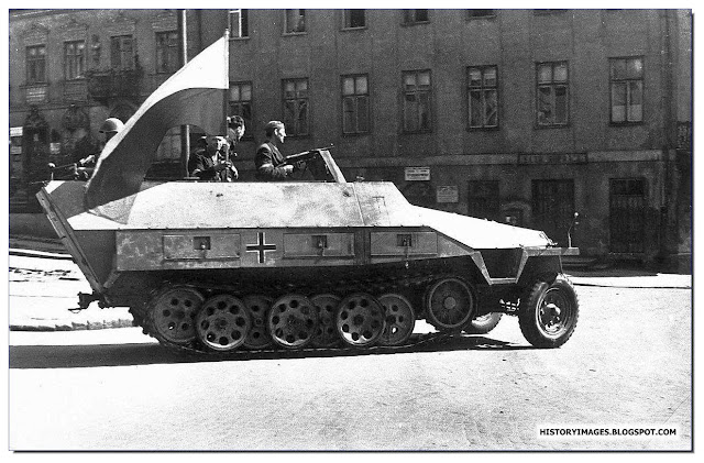 Armia Krajowa fighters ride  captured German armored carrier streets  Warsaw August 1944 uprising
