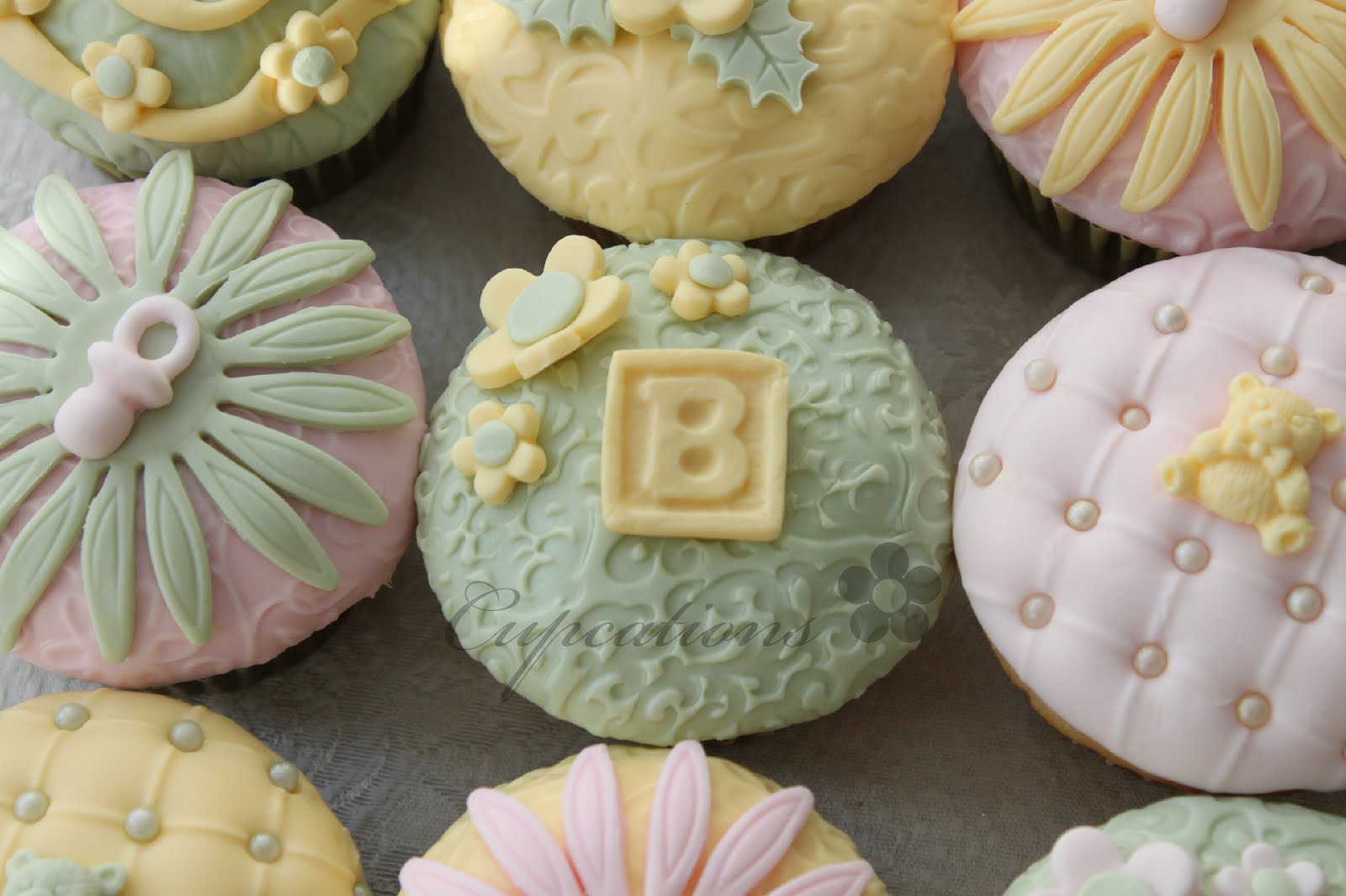 Cupcations Pale Green, Yellow, And Pink... Baby Shower Cupcakes