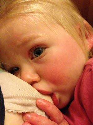 Poorly girly with Hand, Foot & Mouth being comforted by Breastfeeding Toddler breastfeeding with visible blister from Hand, Foot and mouth disease on her hand