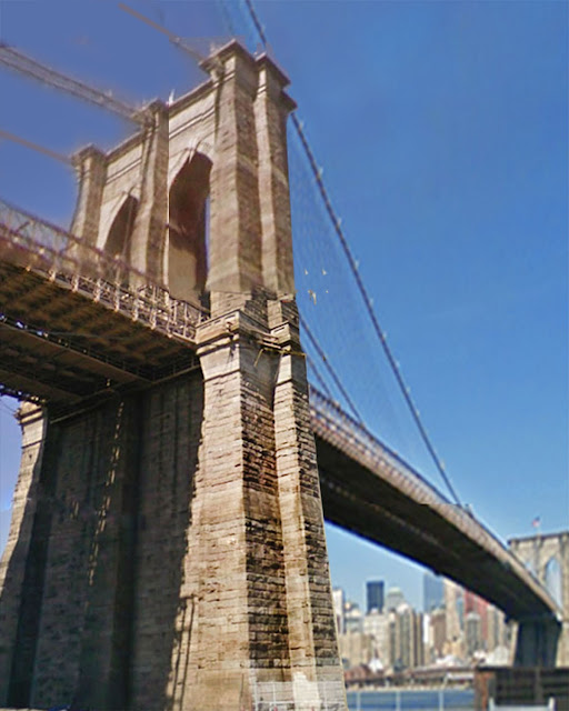 two towers of the brookly bridge shown, with hard afternoon light creating interesting shadows