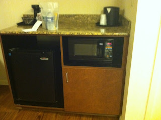 a microwave and mini fridge in a room