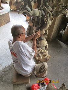 Wood carving artisan at work in Ubud.