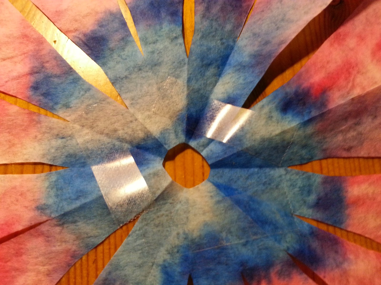 Place some tape on the back side of the flower. We used double sided.