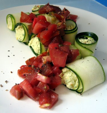 Raw zucchini rolls with cashew cheese and heirloom tomato