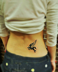 a small black winged horse tattoo on the hip