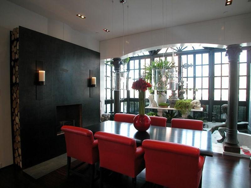 Photo of dining table with red chairs in the dining room